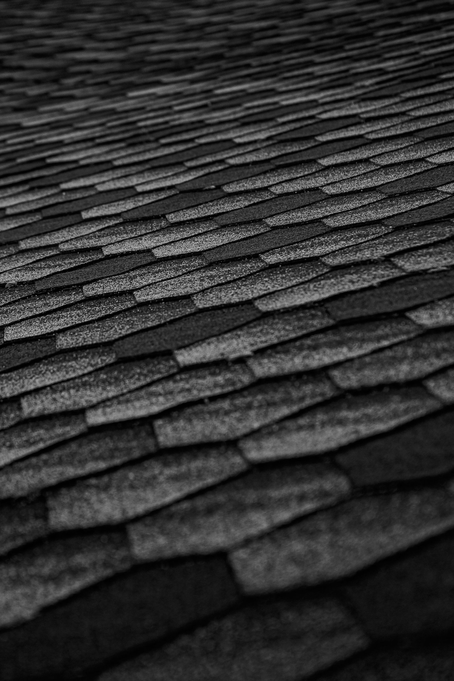 Dark rough surface of path made of black hexagon tiles on city street